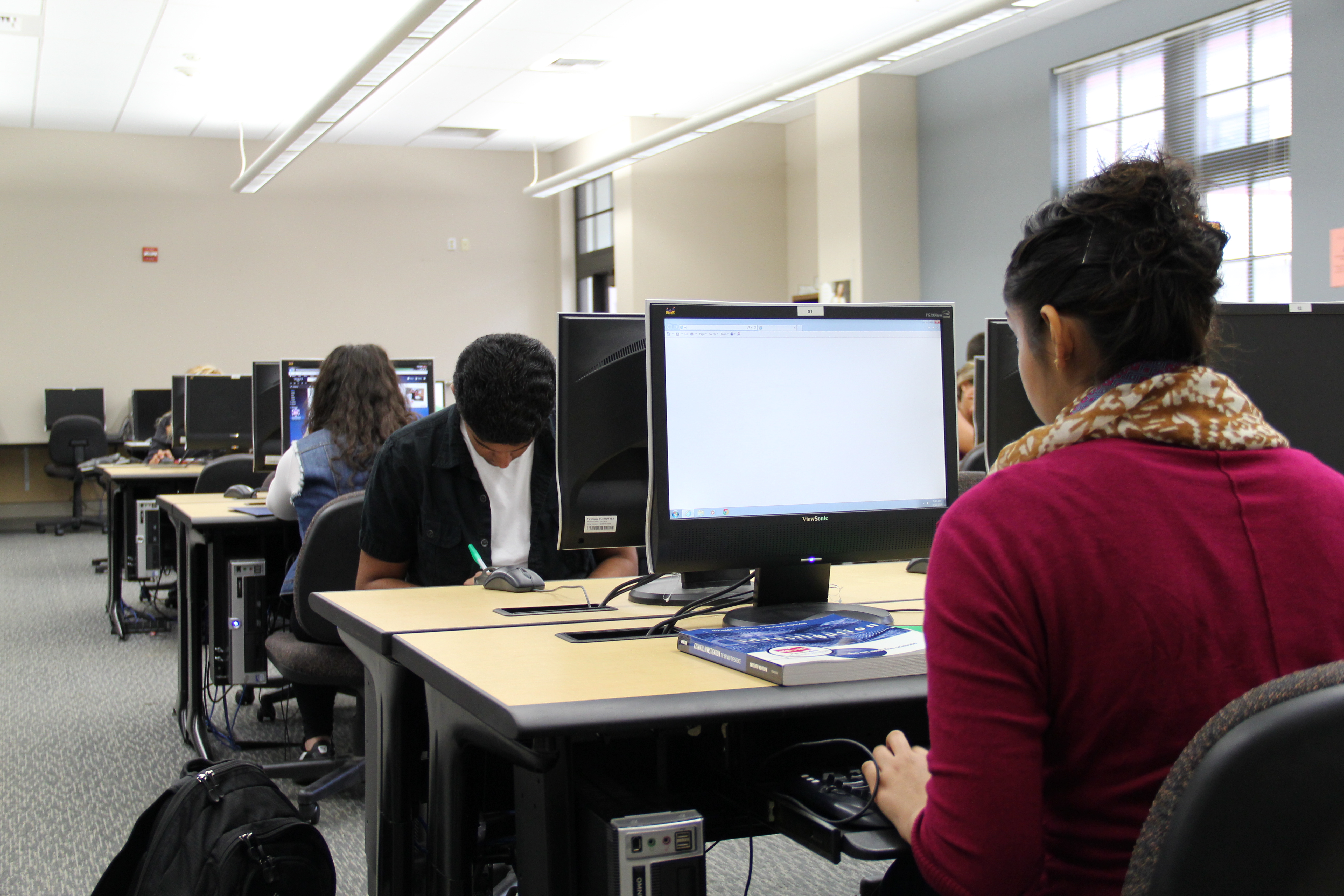 Students working at rows of computers in a Woodland Community College computer lab
