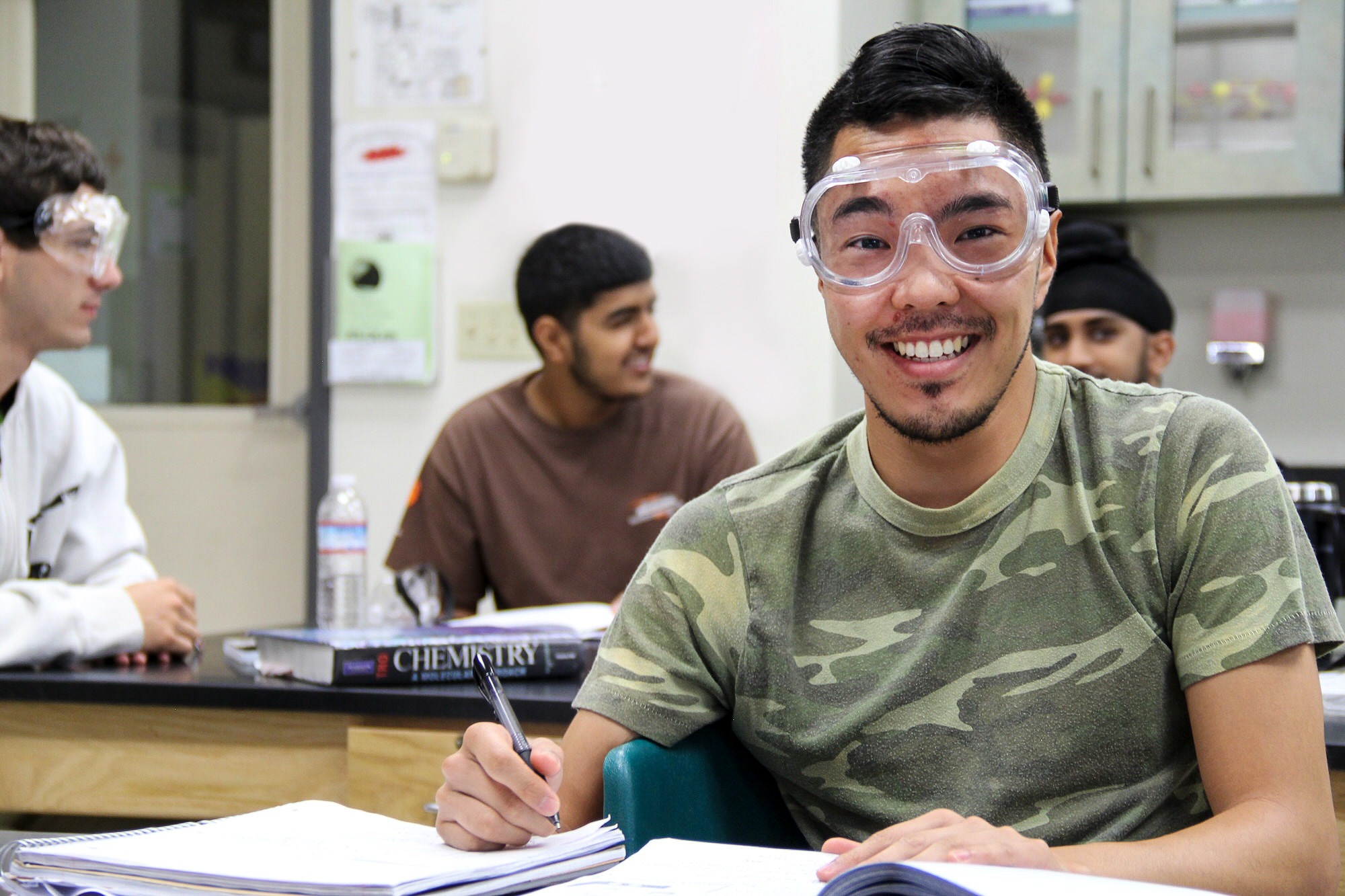 Smiling student wearing chemistry goggles